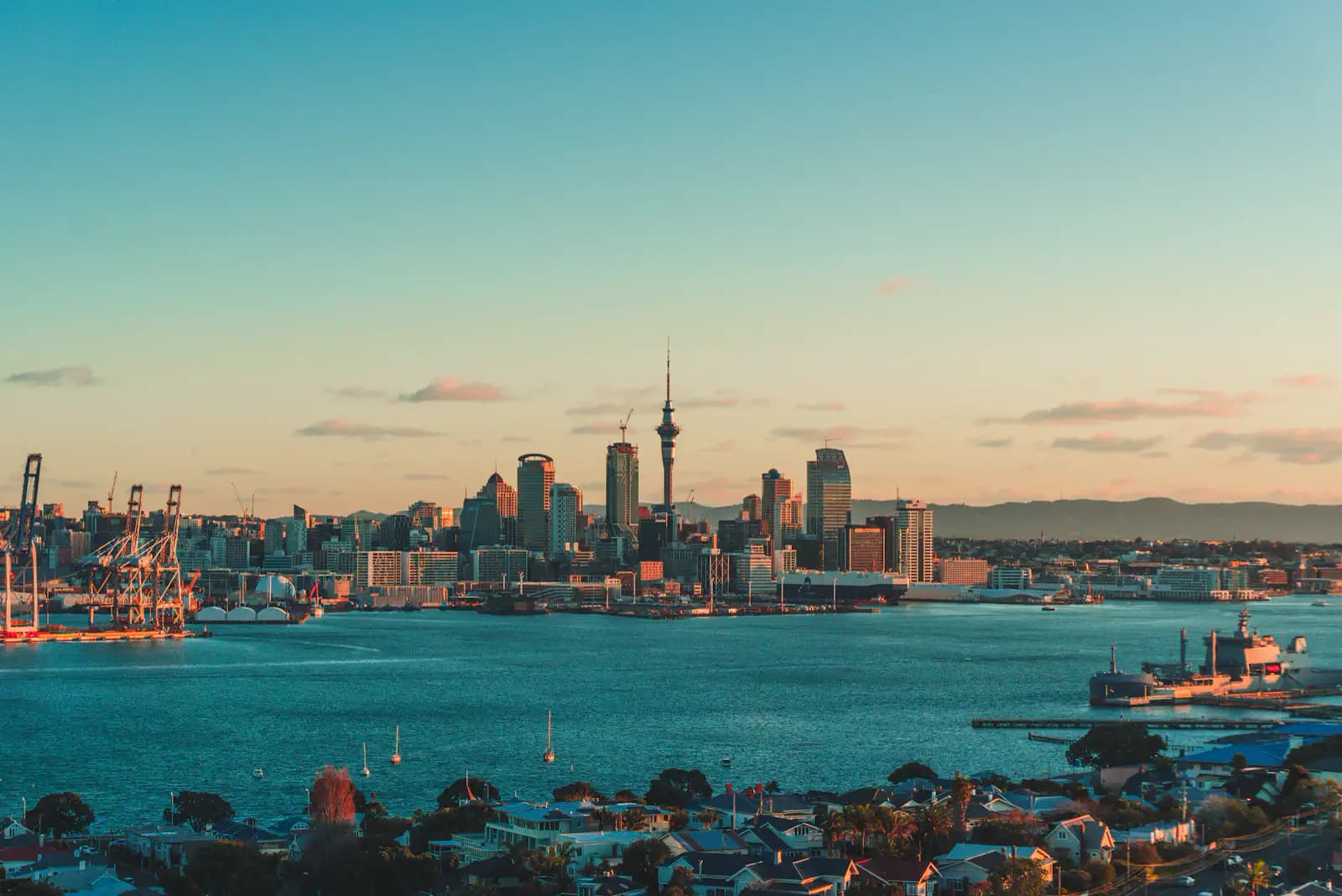 Auckland's skyline and Sky Tower across the harbour at sunset