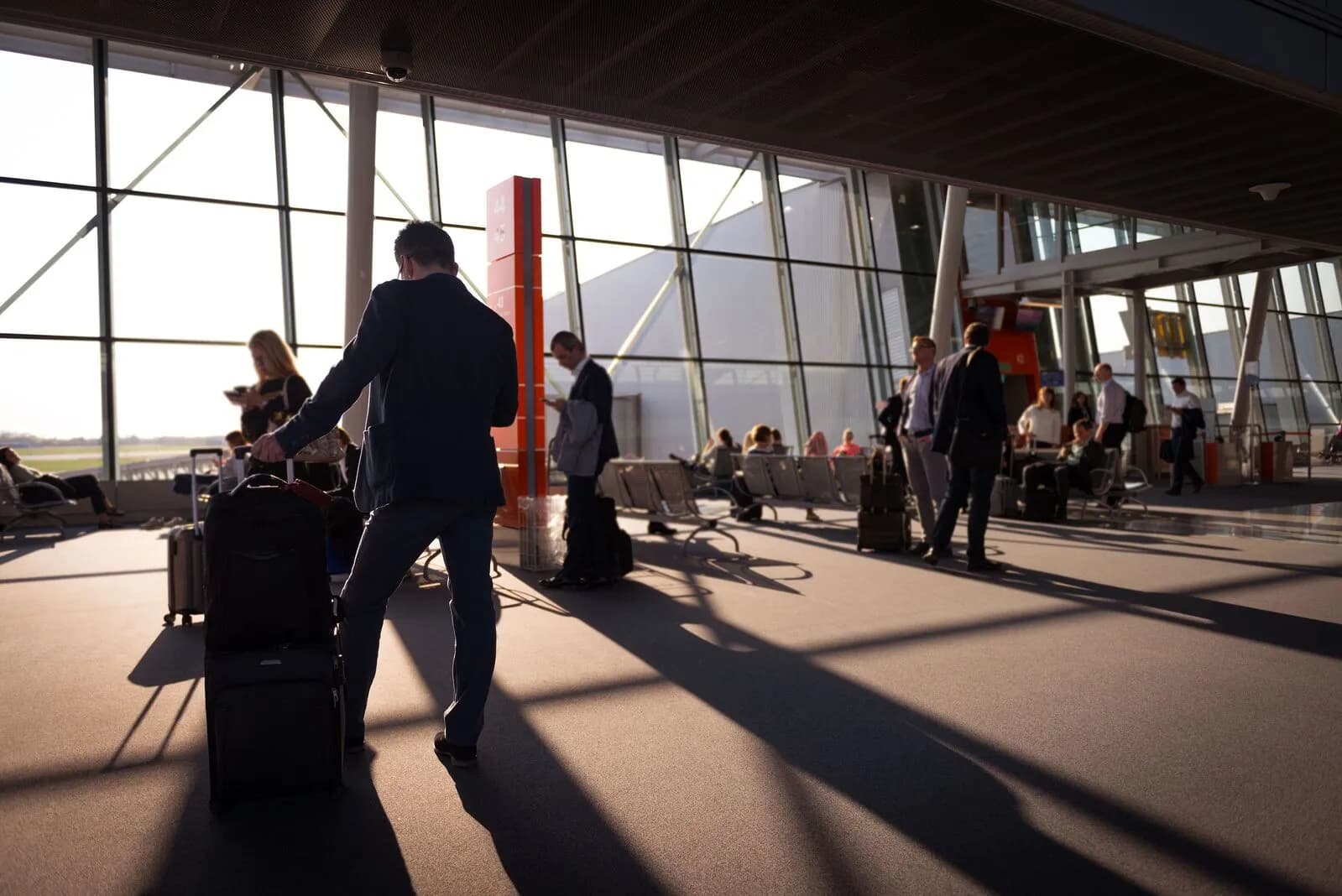Travelers in a bright airport terminal with luggage